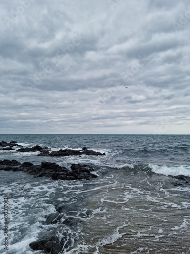 This is a road with a view of the cloudy sky and the sea.