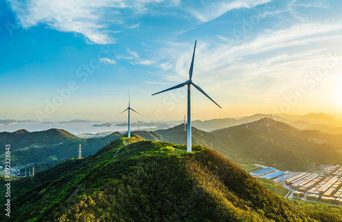 Wind turbines and green mountain nature landscape near the sea.  Green energy concept.  aerial view. photo