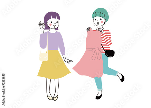 фотографія 洋服が似合うかどうか友達に相談している女性とOKを出している女性
