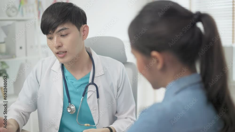 Young asian doctor describing the checking up result to a senior patient in hospital, medical concept. Young asian doctor describing the checking up result to a senior patient in hospital, medical concept.