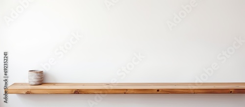Table made of wood against a wall that is white.