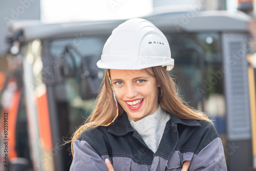 Young engineer female with helmet watching