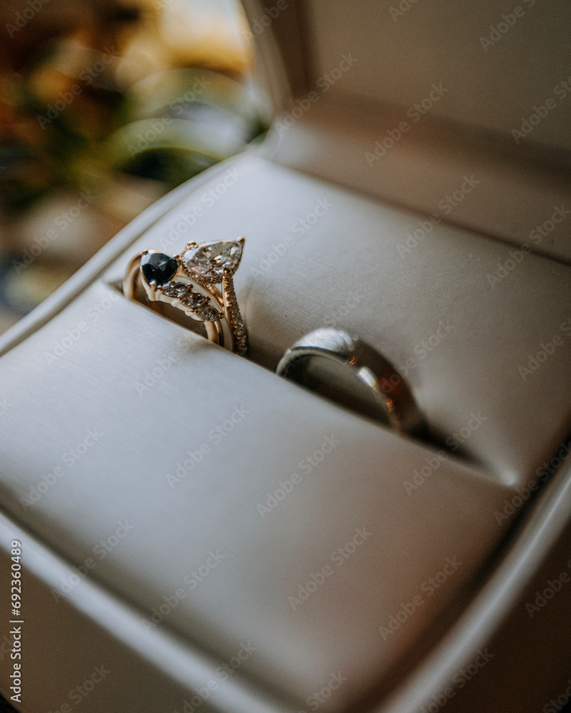 Close up of diamond wedding rings and band in a ring box Close up of diamond wedding rings and band in a ring box