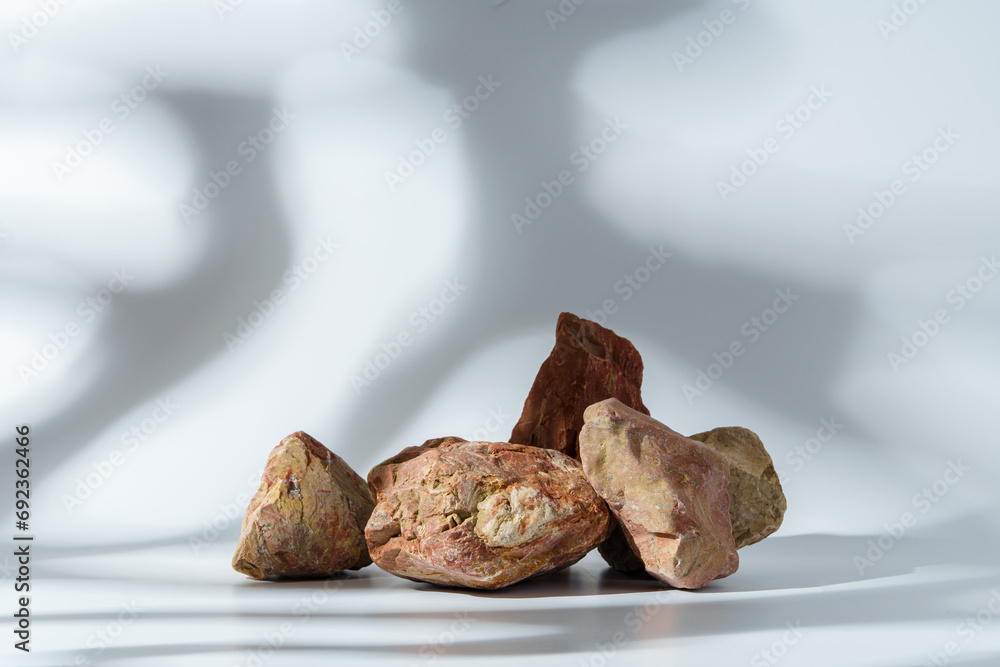 Piece of granite stone on white background with shadows Piece of granite stone on white background with shadows