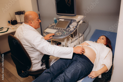 Woman undergoing ultrasound scan in clinic photo