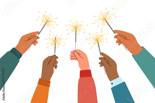 Human hands with sparklers raised upwards. Celebration concept.	
