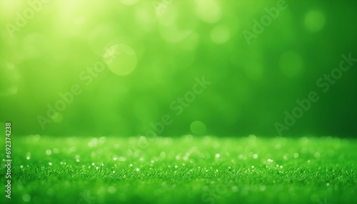 Green grass with dew and bokeh effect. Abstract background.
