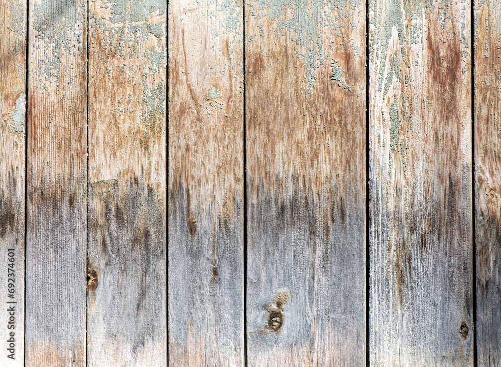 Naklejka premium Boards on an old wooden fence as an abstract background. Texture