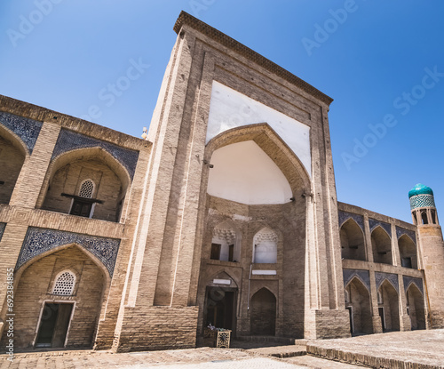 The ancient Kutlug Madrasah of Murad Inak on a sunny summer day in the ancient city of Khiva in Khorezm photo