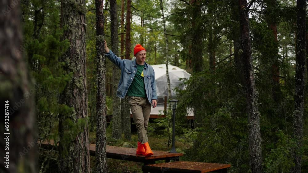 Portrait Of Happy Tourist Man Standing Alone In Forest On Territory Of Modern Glamping Portrait Of Happy Tourist Man Standing Alone In Forest On Territory Of Modern Glamping