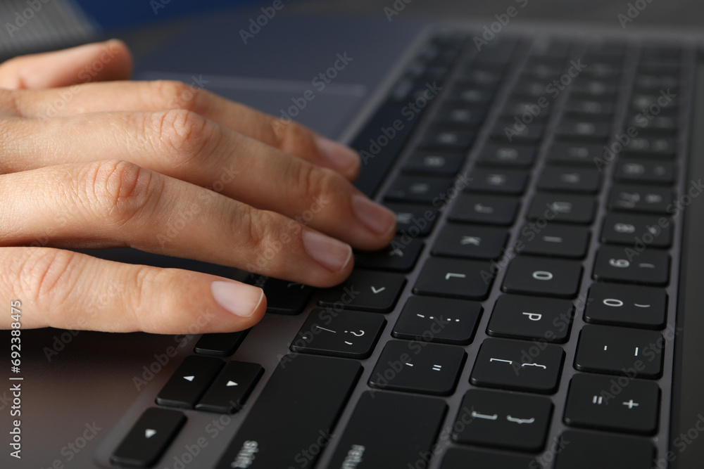 Hands on black laptop keyboard close up view Hands on black laptop keyboard close up view