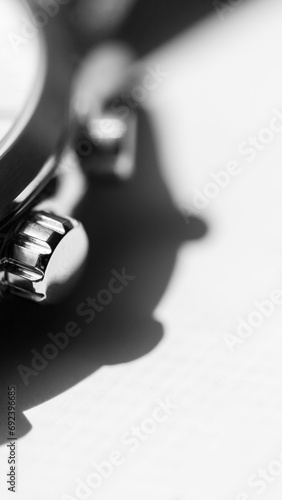 Fototapeta Naklejka Na Ścianę i Meble -  Vertical grayscale shot of details on a luxurious silver watch