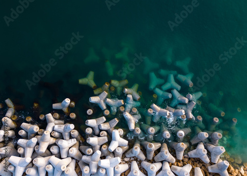 Aerial drone view of a breakwater. breakwater in the sea, a collection of concrete tetrapod breakers photo