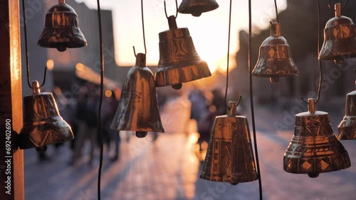 Old traditional bronze, gold bells. Creativity of Uzbek artisans. Evening on a shopping street in the city of Bukhara. Uzbekistan photo