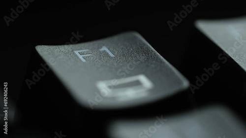 Keyboard button F1. Macro shot of finger pressing F1 button photo