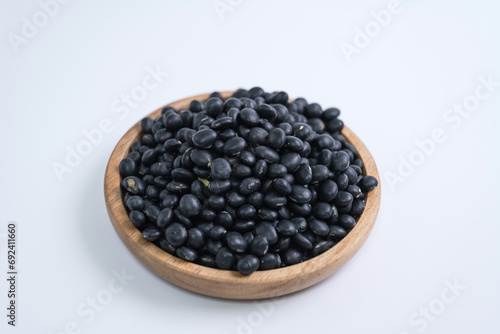 
Black beans, beans, wooden plate, close-up, white background