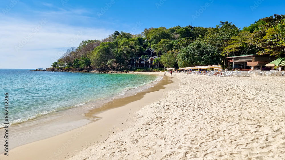 Koh Samet Island Rayong Thailand, the white tropical beach of Samed Island with a turqouse colored ocean on a sunny day with beach chairs on the beach Koh Samet Island Rayong Thailand, the white tropical beach of Samed Island with a turqouse colored ocean on a sunny day with beach chairs on the beach