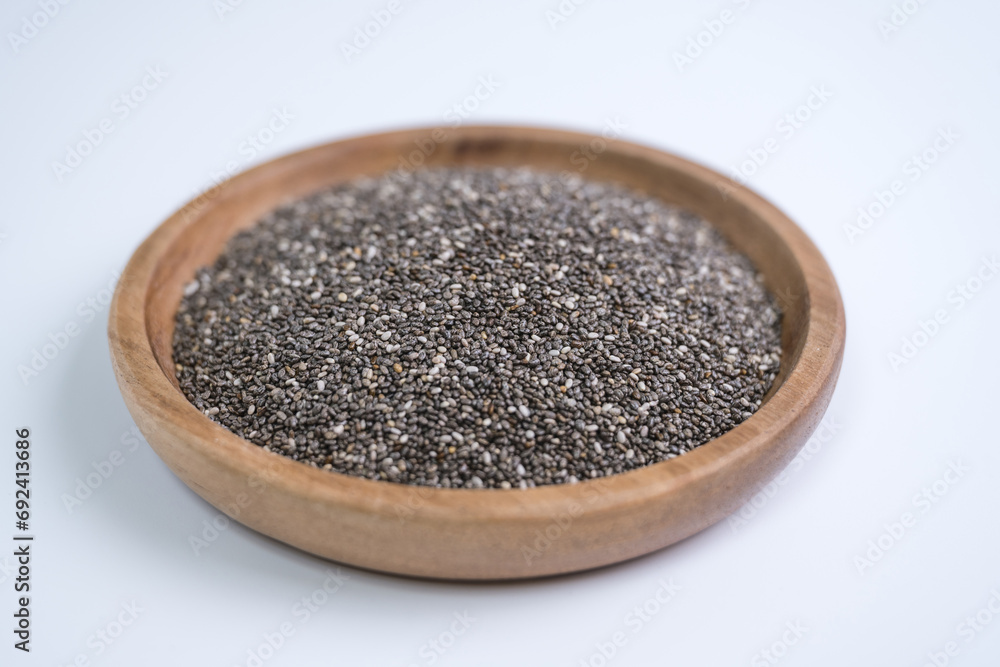 Chia seeds, wooden plate, close-up, white background
Chia seeds, wooden plate, close-up, white background