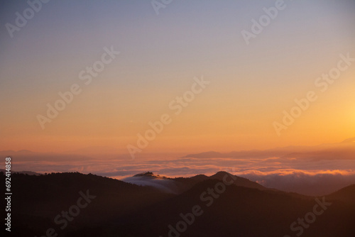 landscape and sky background concept, nature of north Thailand, fog-laden valleys, wintery mountain passes of Chiang mai province, top view on the mountain sunrise.