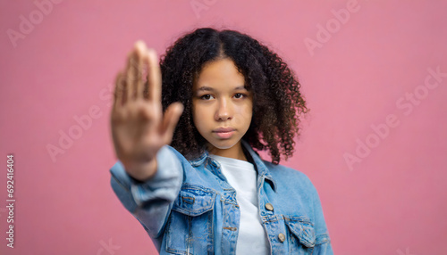 Black girl with her hand in front, concept no to child abuse, no mistreatment of women © Demencial Studies