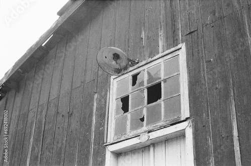 Broken window on old wooden house