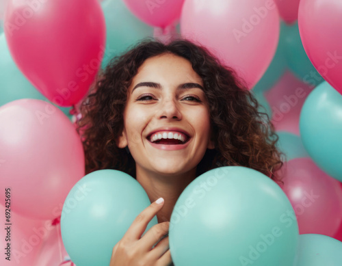 Portrait of beautiful Eastern girl with colorful balloons at party.