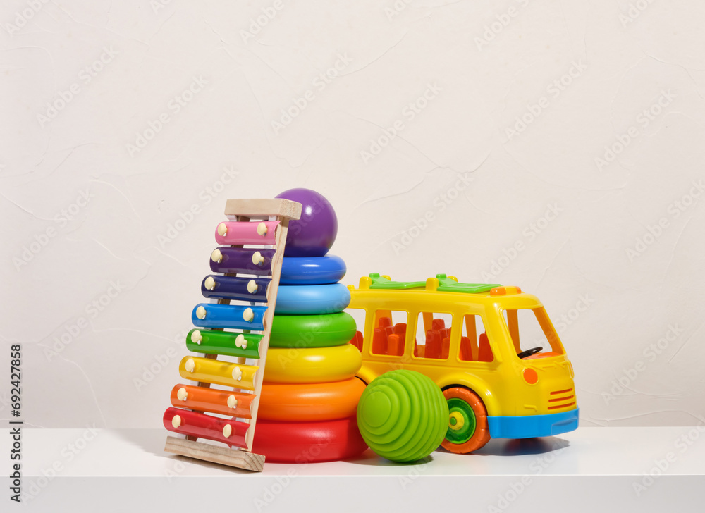 Xylophone piano, pyramid with colored rings, car and tactile or sensory balls. Educational toys. Xylophone piano, pyramid with colored rings, car and tactile or sensory balls. Educational toys.