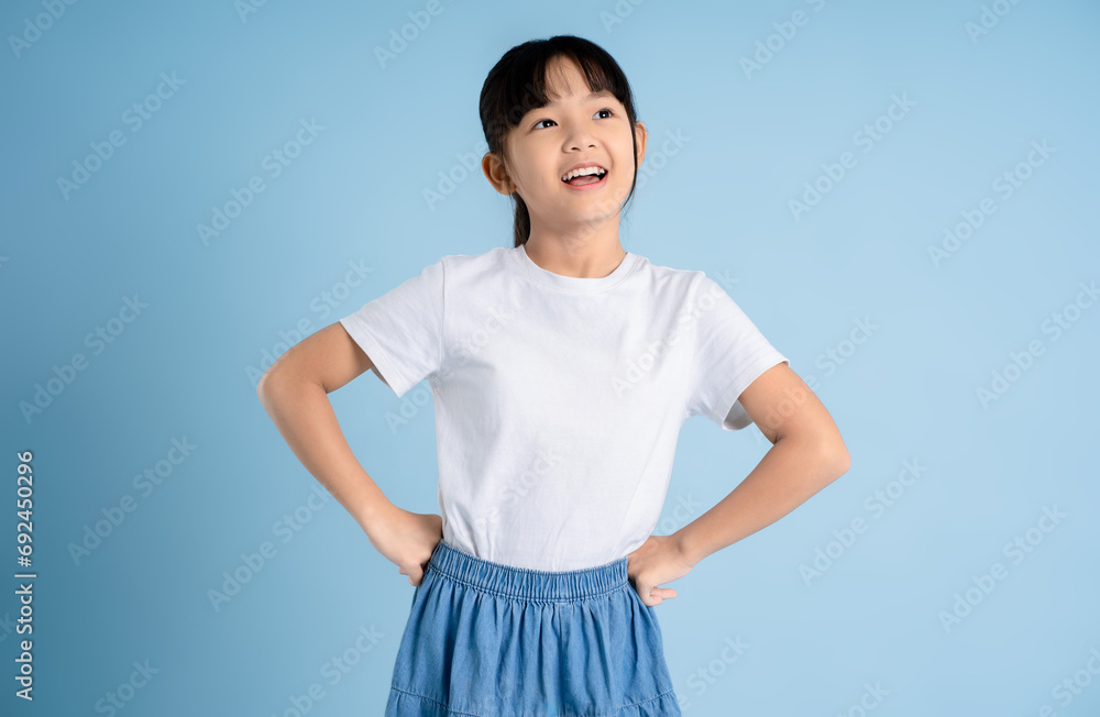 Portrait of Asian girl posing on blue background Portrait of Asian girl posing on blue background