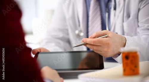 Male doctor hands hold and show digital tablet pc to patient explaining diagnosis. Physical disease prevention 911 therapeutist prescribe remedy healthy lifestyle modern technology concept