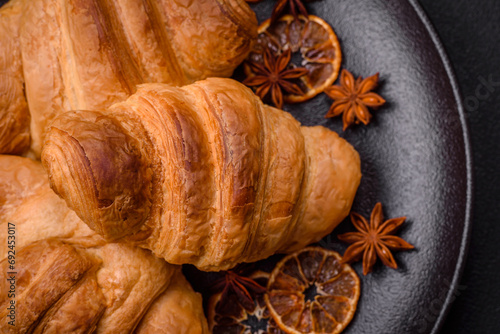 Delicious crispy baked sweet croissants with filling on a ceramic plate