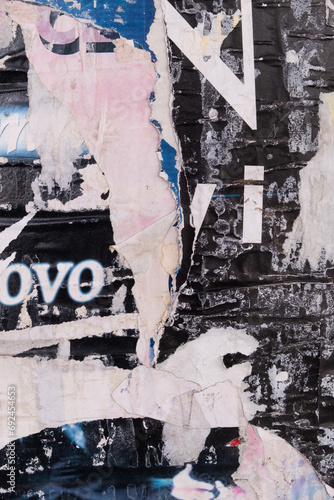 Vertical torn and ripped street poster background, abstract and messy old grungy paper collage