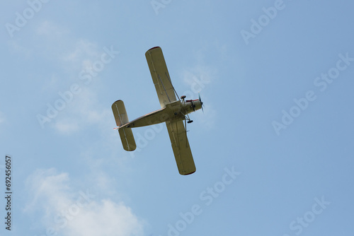 The plane is flying in the sky against the background of clouds