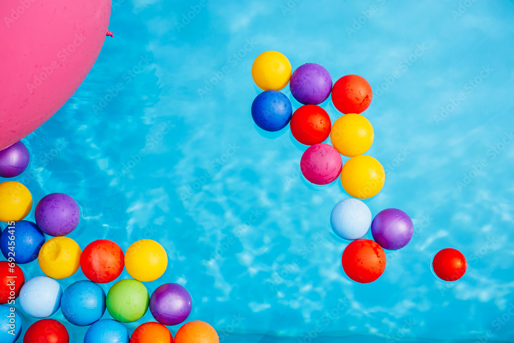 Swimming pool with blue water and colorful balloons Swimming pool with blue water and colorful balloons