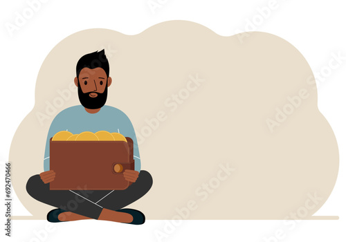 A man sits cross-legged and holds a large purse of coins. The concept of a savings wallet, a successful loan, golden earnings with metal money in the currency.