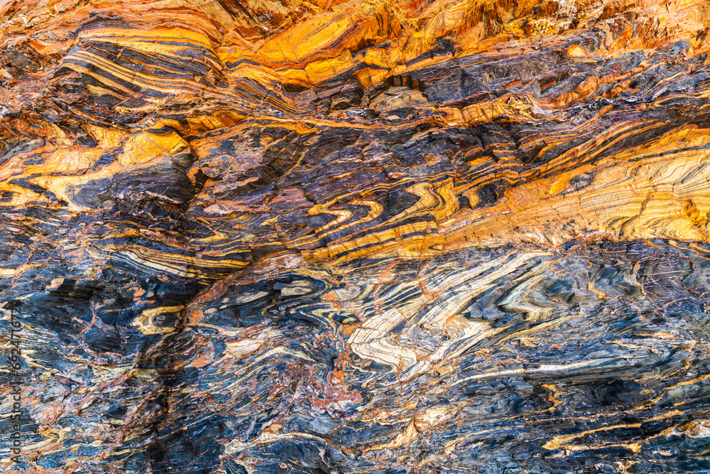 Naklejka premium Natural marble stone background with cracks and colourful layers in Second Valley, South Australia