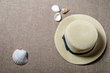 vacation flat view with straw hat and sea shells