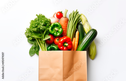 Paper bag with fresh vegetables isolated on white background with copy space, top view