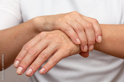 Woman hands showing wrist pain over cropped body photo