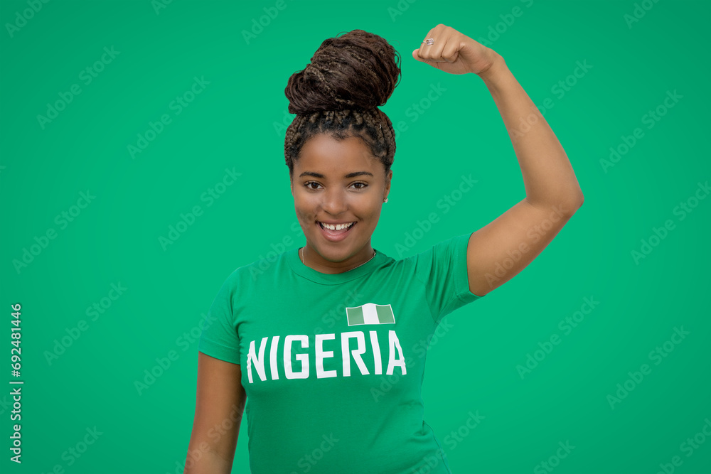 Fototapeta premium Cheering football supporter from Nigeria with green jersey