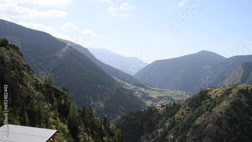 panoramic of canillo in andorra seen from the metal suspension bridge on a sunny day between the mountains photo