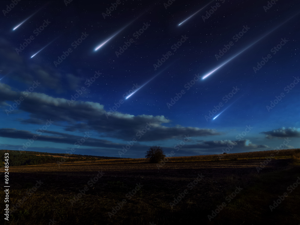 Beautiful starfall in the twilight sky. A stream of meteors reached the