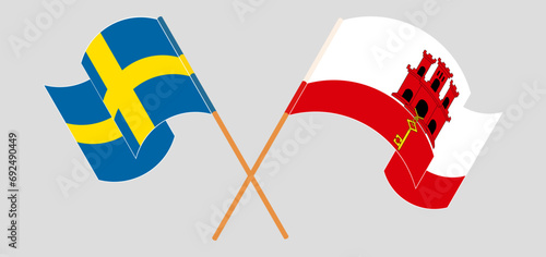 Crossed and waving flags of Sweden and Gibraltar