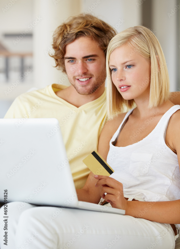 Couple, credit card and laptop for online shopping, loan registration or digital money on sofa at home. Young woman and man relax on computer for internet banking, website payment or e commerce order Couple, credit card and laptop for online shopping, loan registration or digital money on sofa at home. Young woman and man relax on computer for internet banking, website payment or e commerce order