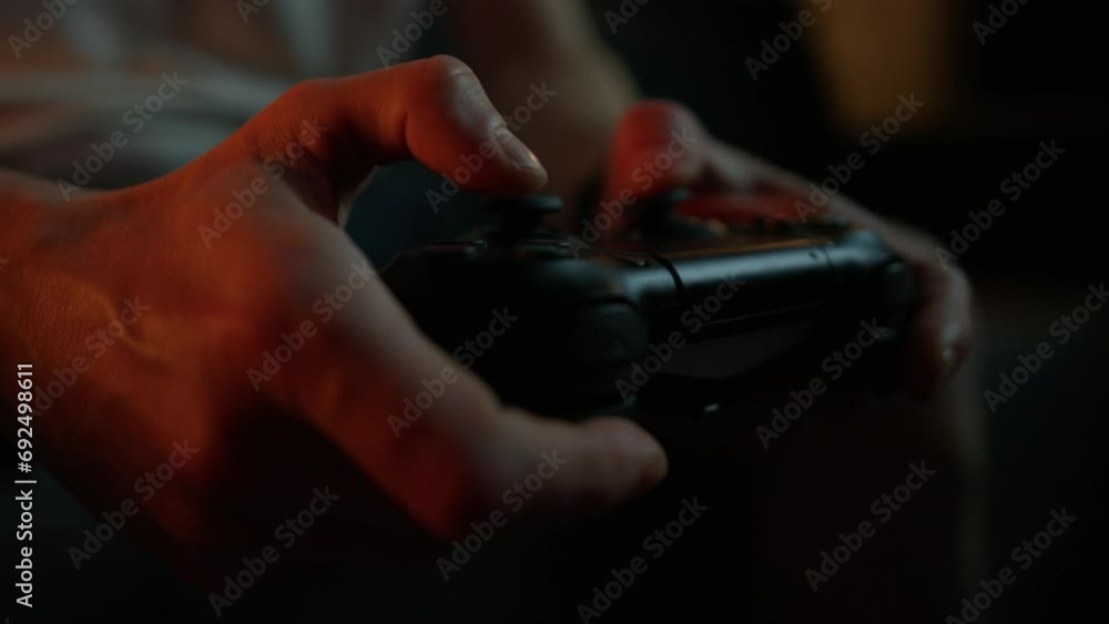 Close-up of a man's hands holding a joystick from a video console Close-up of a man's hands holding a joystick from a video console