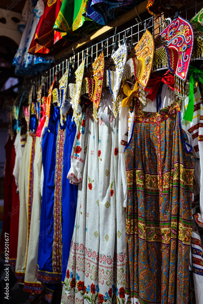 Traditional clothes hang on hangers at street trade