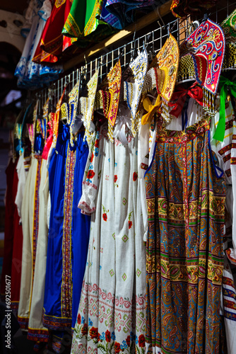 Traditional clothes hang on hangers at street trade
