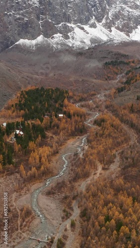 Mount Karatash in Aktru Valley in Autumn. The Altai Mountains. Russia. Aerial View. Reveal Shot. Vertical Video photo