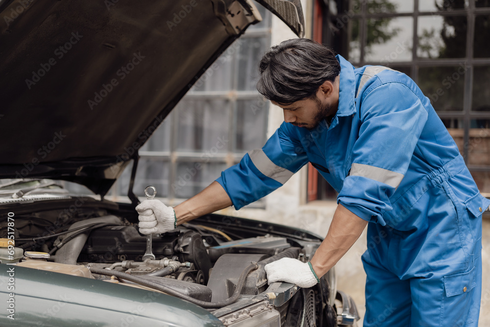 car engine service concept Car mechanic checks car engine with car repair inspection, car service and maintenance, checks oil in car engine.