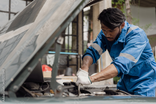 car engine service concept Car mechanic checks car engine with car repair inspection, car service and maintenance, checks oil in car engine.