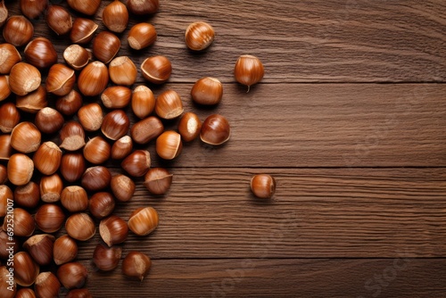 hazelnuts spilled on a wooden table - overhead view